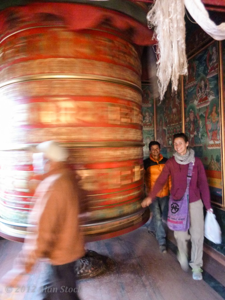 Sophie and Jhabraj spin a giant prayer wheel